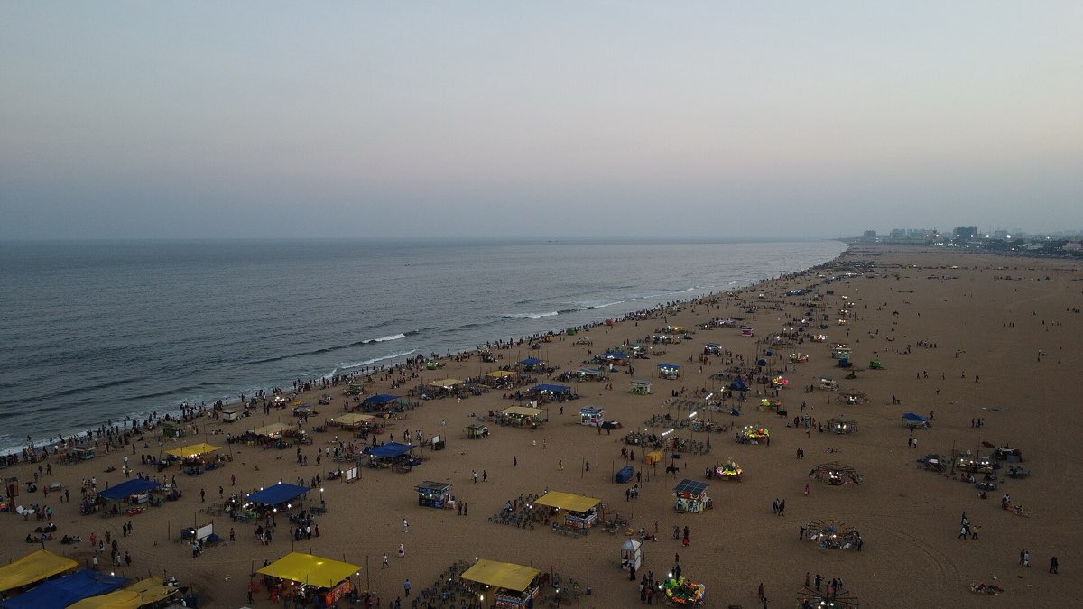 Marina Beach at dusk, stalls and crowds along the sand