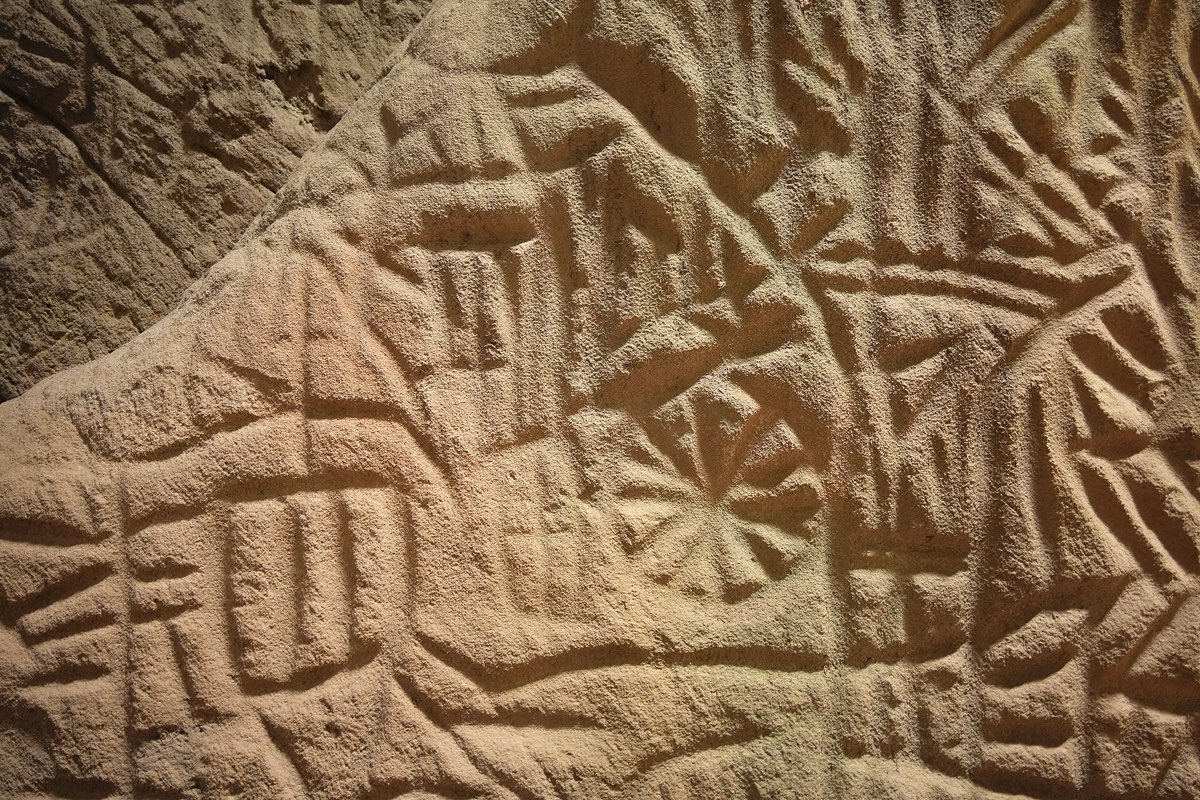 Prehistoric petroglyphs on the rock face inside the Edakkal Caves