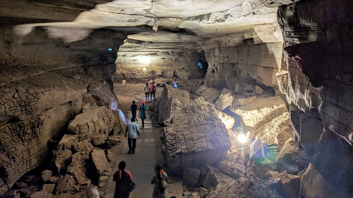 Visitors walking through a lit gallery inside Belum Caves